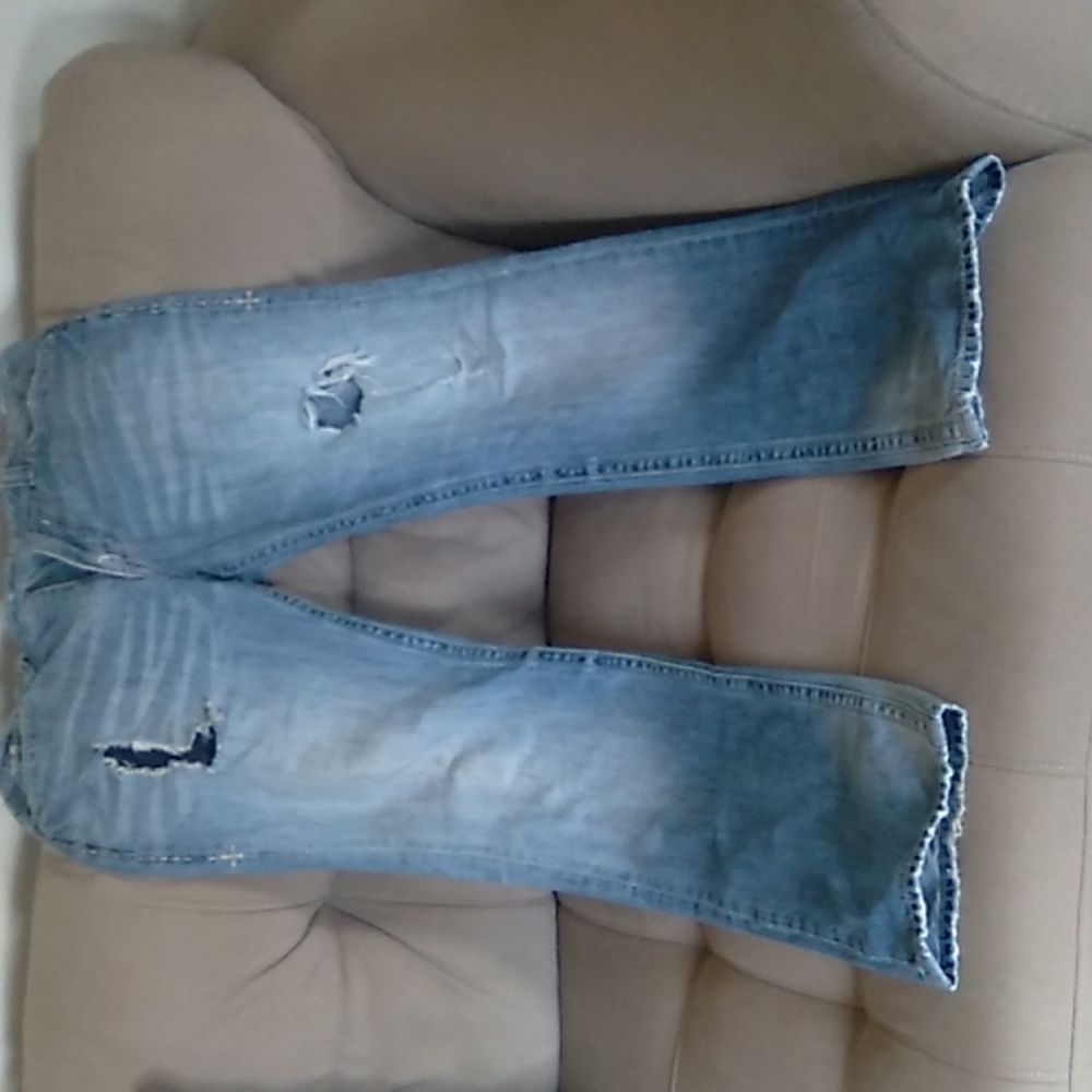 Pair of Affliction jeans ripped style